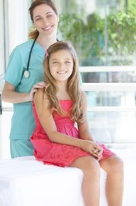 Woman doctor with girl patient